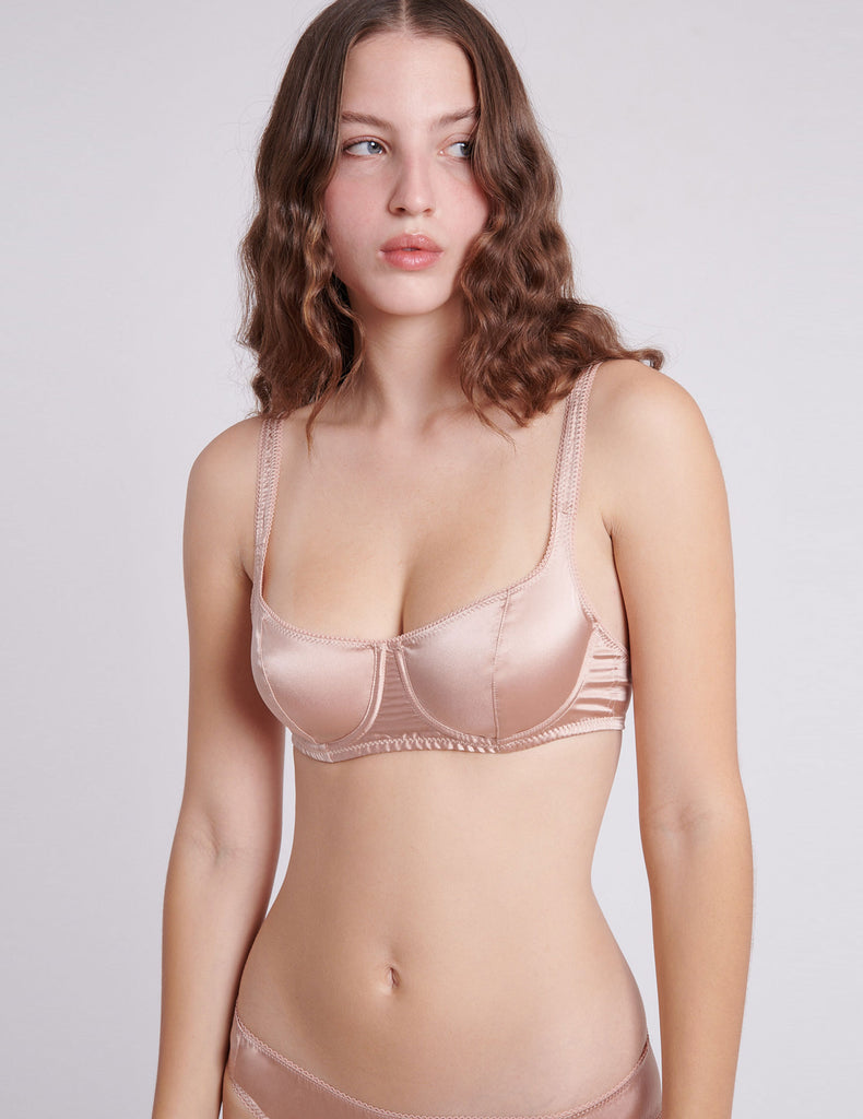 close up of nude silk bra on woman 