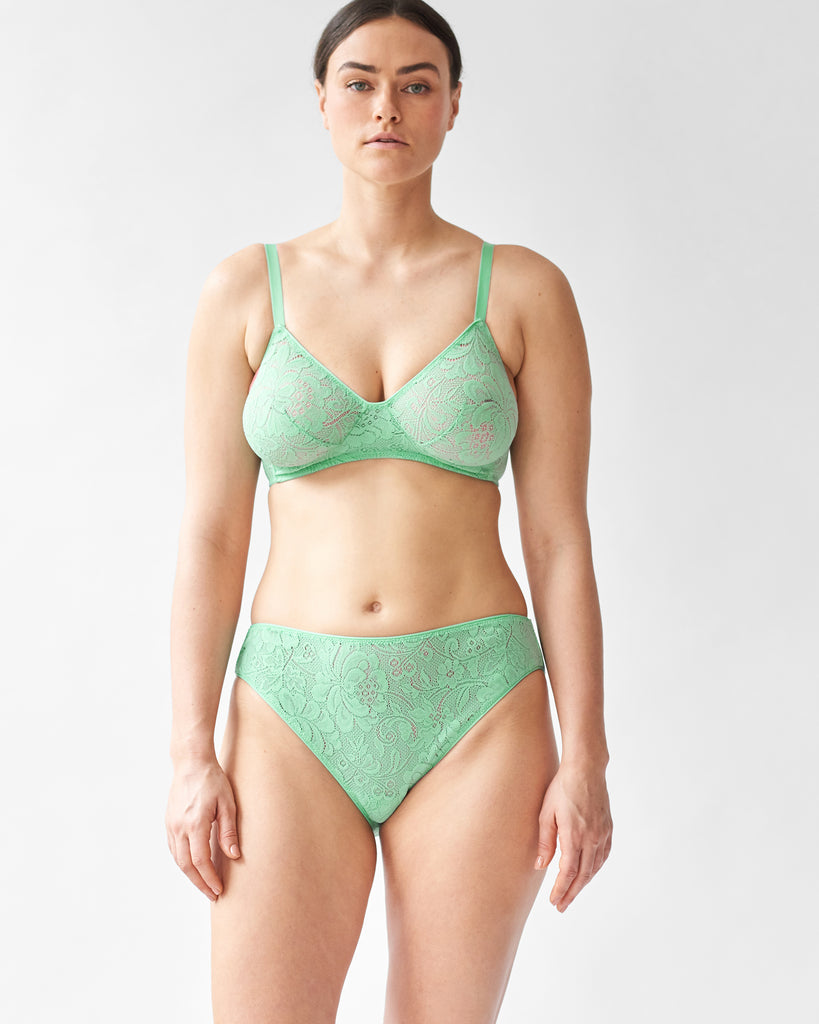 woman wearing green lace wireless bra and matching high waist panty by Araks