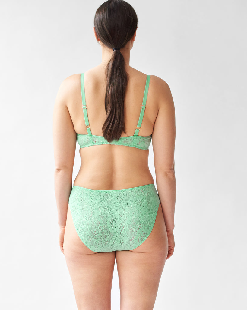 back of woman wearing green lace wireless bra and matching high waist panty by Araks
