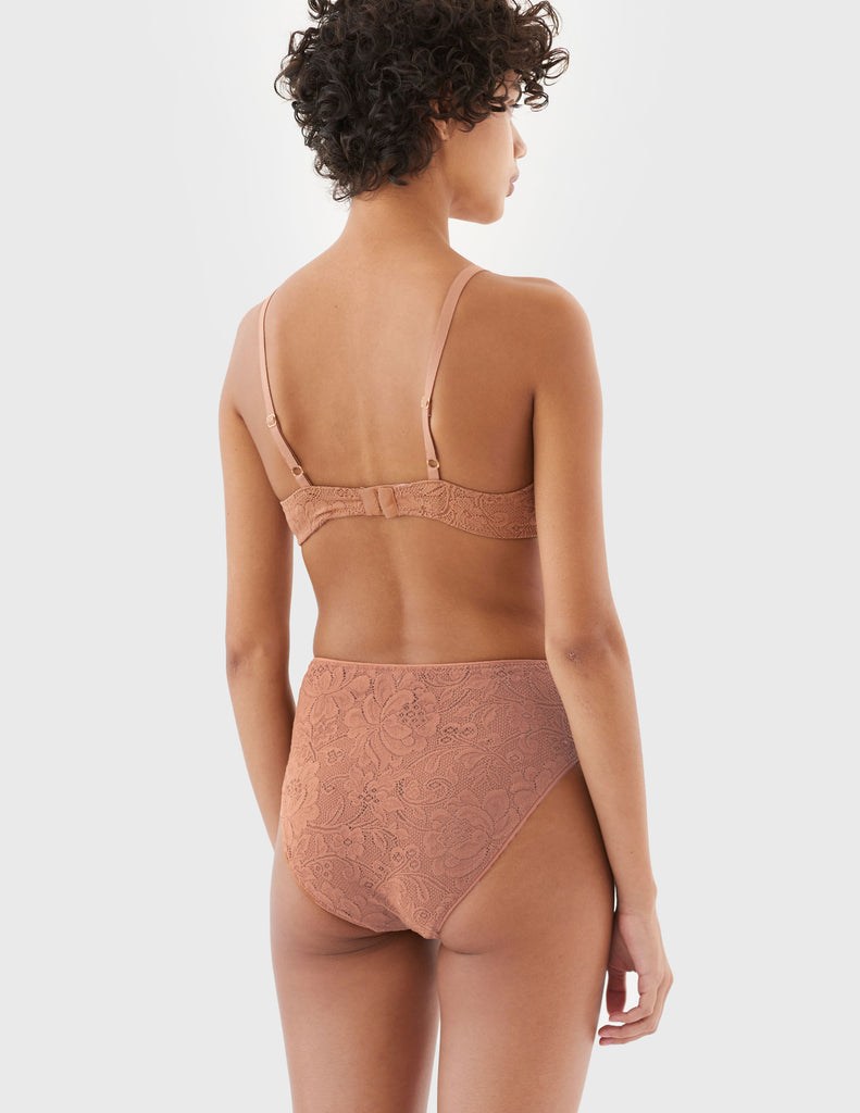 back of woman wearing brown lace underwire bra and high waisted panty