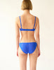 On model image of back of blue lace panty and bralette
