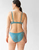 Backview of woman wearing blue wireless blue lace bra and matching panty