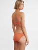 woman wearing orange lace wireless bra and matching panty by Araks