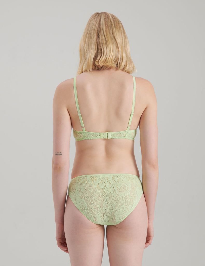 back view of woman in green lack bra and panty 