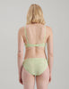 On model image of back of  green lace panty and bralette