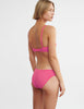 woman wearing pink lace bralette and matching panty by Araks