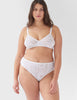 Front view of woman wearing white lace panty with matching bralette