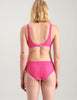  back view of woman wearing pink stretch lace hipster and matching soft cup bra.