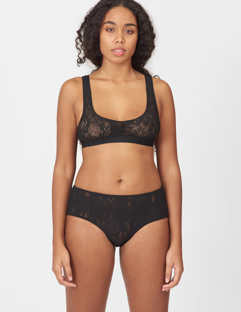 A woman wearing a black lace bra and hipster by Araks