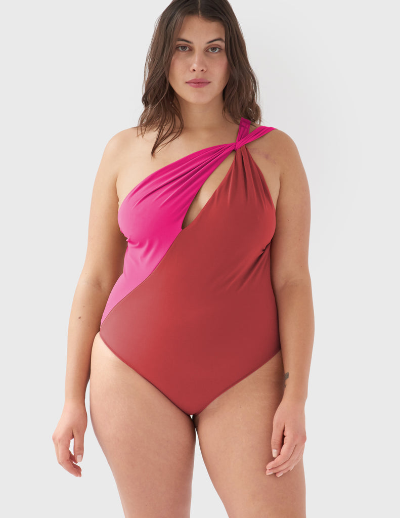 Front view of woman wearing a pink and red one piece swimsuit