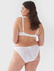 Face away, woman wearing white, lace mid-rise panty with matching underwire bralette.