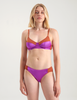 A woman wearing a brown cotton bra with purple silk insert with matching panties by Araks