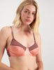 closeup of woman wearing orange and brown cotton and silk bralette with matching panty by Araks