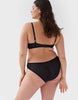 Back view of woman wears black mesh underwire bra and matching panty. 