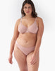 Front view of woman wears beige mesh underwire bra and matching panty. 