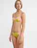 woman wearing pink cotton wireless bralette with green silk insert and matching panty by Araks