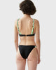 back of woman wearing black bikini with white, green, blue and black straps by Araks